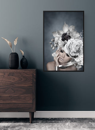 Silver flowers 2 poster featuring a woman with an elaborate floral headpiece in grayscale on a dark wall.