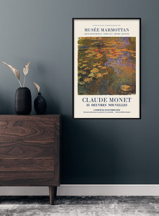 Claude Monet Musée Marmottan poster featuring a water lilies painting, framed and hung on a dark wall above a dresser.