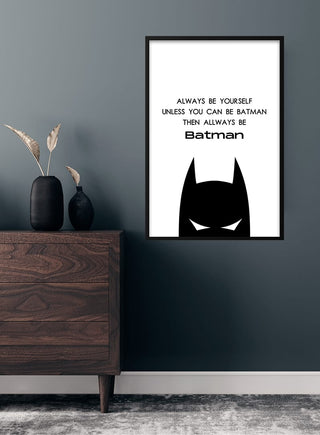 Framed Batman poster with inspiring quote, hanging on a dark wall in a modern child's room.