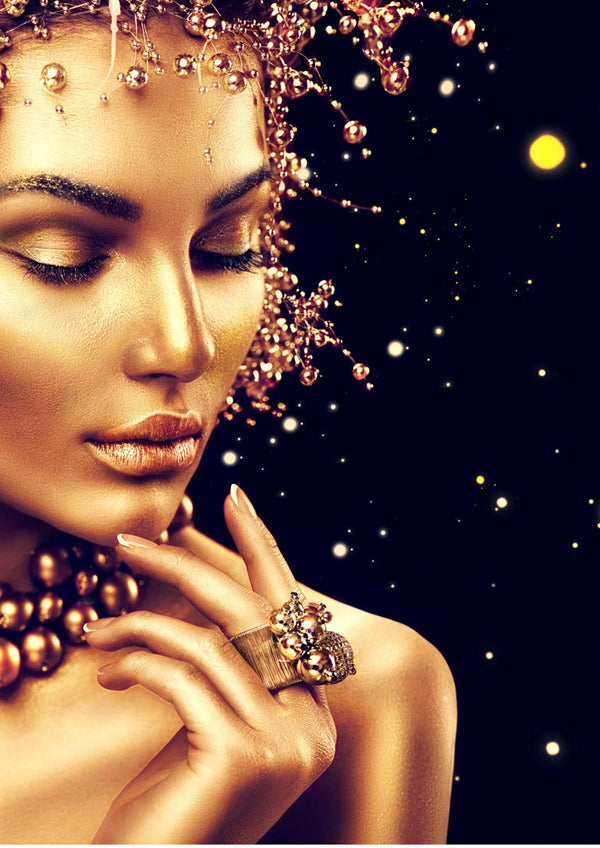 Golden fashion poster featuring a glamorous woman with gold makeup, jewelry, and sparkling decorative elements.