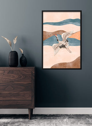 Framed Japanese crane art poster with abstract background, displayed above a wooden dresser in a modern room.