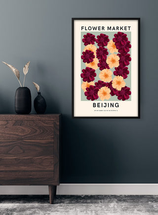 Framed Flower Market - Beijing Plakat featuring red and yellow flowers hanging on a dark wall above a wooden dresser.