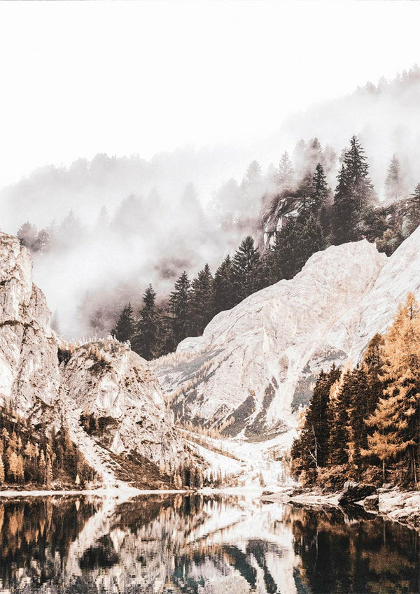 Poster of a tranquil mountain lake with mist, rocky cliffs, and pine trees reflected in the water.