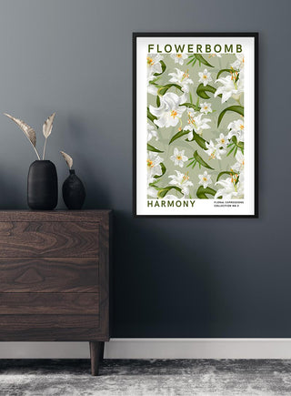Flowerbomb - Harmony Plakat featuring white flowers and green leaves, framed and hung on a dark wall above a dresser.