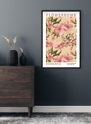 Framed Flowerbomb - Romance Plakat with pink floral design, hung on a dark wall above a wooden dresser.