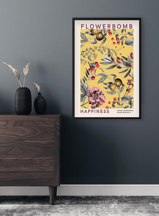 Flowerbomb Happiness Plakat featuring colorful floral artwork, framed and hung on a dark gray wall.