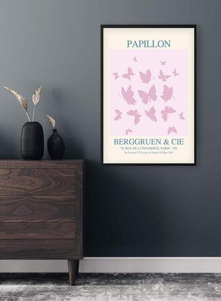 Inspired Papillon No. 02 Plakat featuring pink butterflies on a light background, framed and hung above a wooden dresser.
