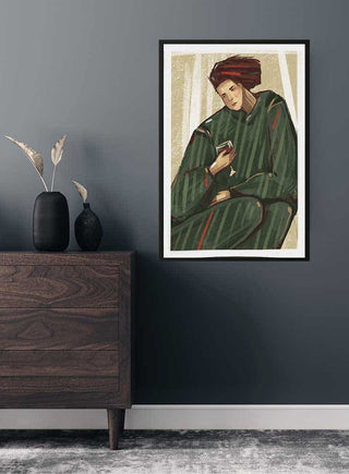 Framed Sipping Wine Plakat on a dark wall above a wooden dresser with vases and pampas grass.