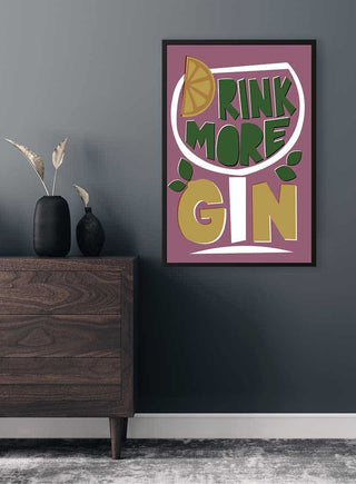 Framed "Drink More Gin" poster with bold text and lemon slice, displayed on a modern wall above a dresser.