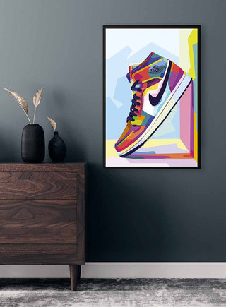 Colorful Air Jordan sneaker art print in a modern frame, displayed on a dark wall above a wooden dresser.