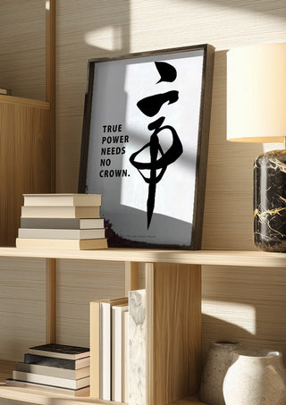 Mikado by KOUYOU KITAZUMI in a dark frame on a wooden shelf beside books and a lamp