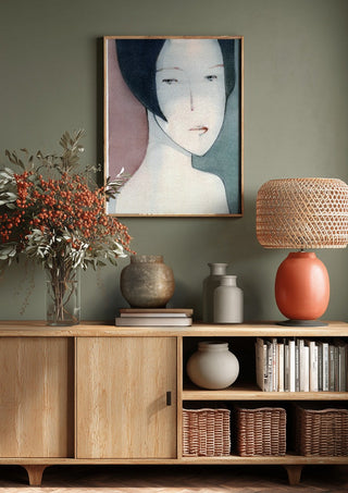 A Child by Designus above a wooden sideboard on a sage green wall