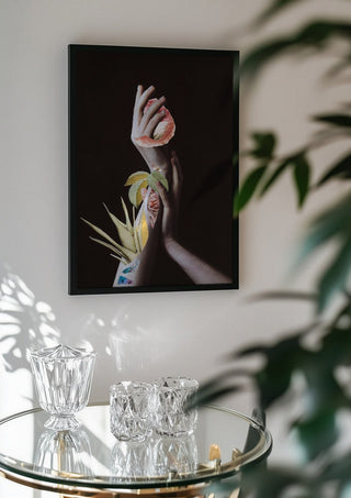 Hypnopompic by Rocio Montoya in a black frame above a glass table with crystal glassware