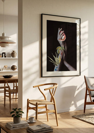 Hypnopompic by Rocio Montoya in a black frame in a bright dining room with wooden chairs