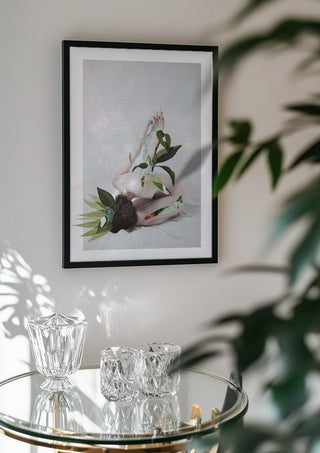 Letargo II by Rocio Montoya in a black frame above a glass table with crystal glassware