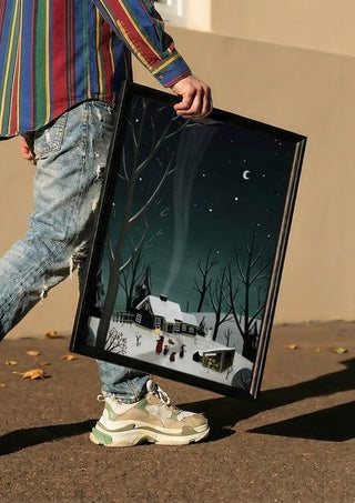 winter night by Justyna carried in a black frame along a sunny street