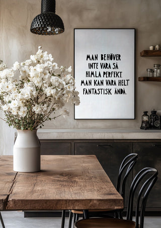 Fantastisk by Grafik bageri in a black frame above a rustic table with white flowers