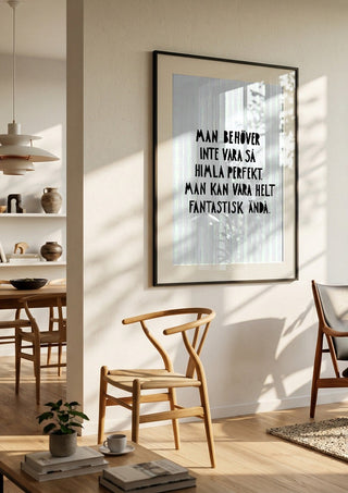Fantastisk by Grafik bageri in a black frame in a bright dining room with wooden chairs
