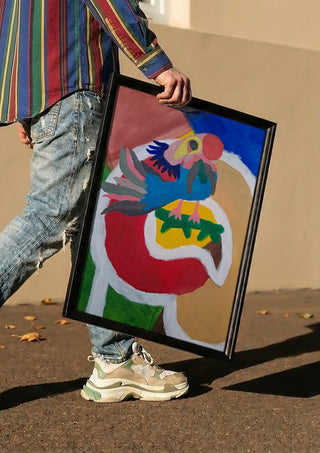 Befriad fågel by Hampus Nerén carried in a black frame along a sunny street