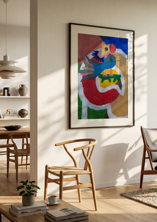 Befriad fågel by Hampus Nerén in a black frame in a bright dining room with wooden chairs