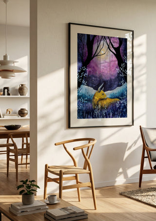 Where the Sky Breathes by Evgenia Smirnova in a black frame in a bright dining room with wooden chairs
