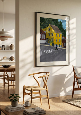 Low sun forever by Jaron Su in a black frame in a bright dining room with wooden chairs