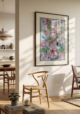 Dreaming The White Dots by Art Guveau in a black frame in a bright dining room with wooden chairs