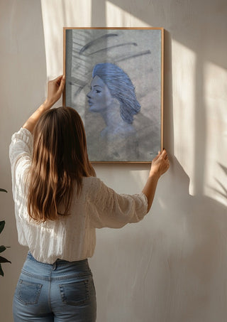 Blue Profile by Allheartsportraits being hung on a sunlit wall