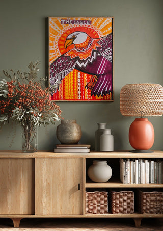 Eagle in the sky by ALEX above a wooden sideboard on a sage green wall