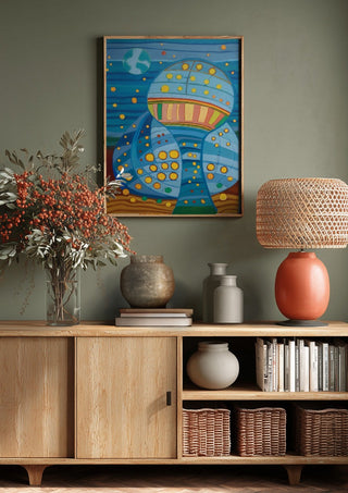 Once upon a blue moon by Gerard Ceulemans above a wooden sideboard on a sage green wall