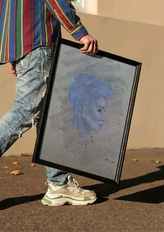Portrait in Blue by Allheartsportraits carried in a black frame along a sunny street