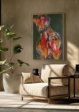 Red Figure by René J framed above a beige armchair beside a potted plant