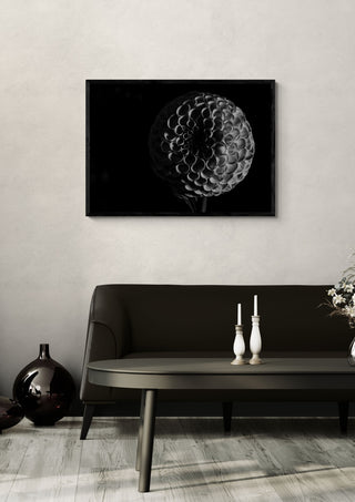 Lunar Bloom by Guido Lucker in a black frame above a dark sofa with candlesticks and a vase