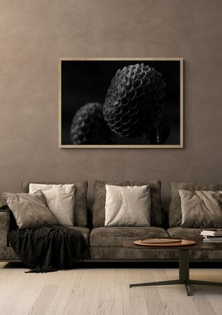 Lunar Bloom II by Guido Lucker in a light wood frame above a grey sofa with cushions