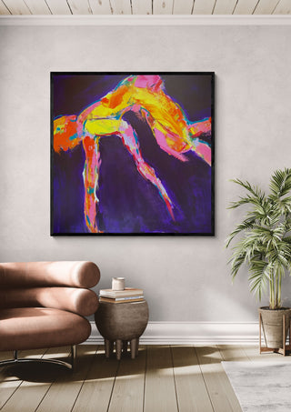 Leap by René J in a black frame above a tan leather chair beside a potted plant