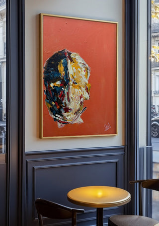 Head in Colour by René J in an oak frame on a panelled café wall