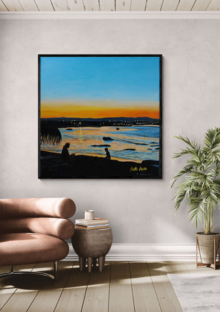 Last Rays by Nella Hajdu in a black frame above a tan leather chair beside a potted plant
