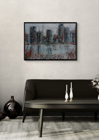 City Across the Water by luco art in a black frame above a dark sofa with candlesticks and a vase