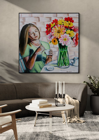 Peaceful Morning by Nella Hajdu in a black frame above a grey sofa with a round coffee table and candlesticks