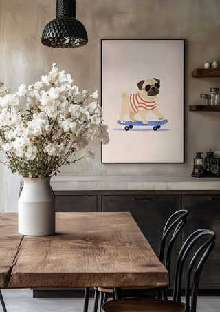Pug on a Skateboard by Decker Studios in a black frame above a rustic table with white flowers