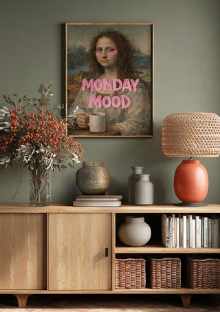 Monday Mood by Decker Studios above a wooden sideboard on a sage green wall