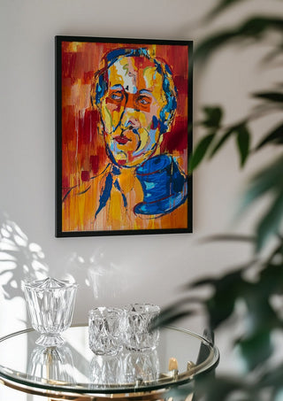 Man in a Blue Hat by René J in a black frame above a glass table with crystal glassware