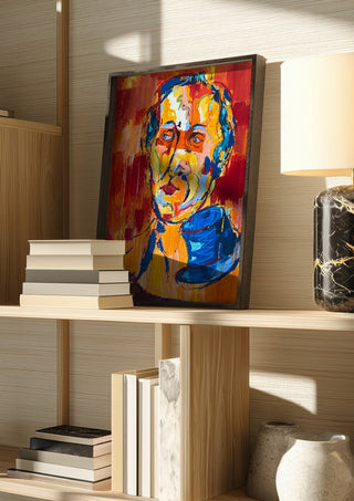 Man in a Blue Hat by René J in a dark frame on a wooden shelf beside books and a lamp