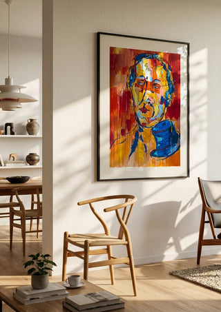 Man in a Blue Hat by René J in a black frame in a bright dining room with wooden chairs