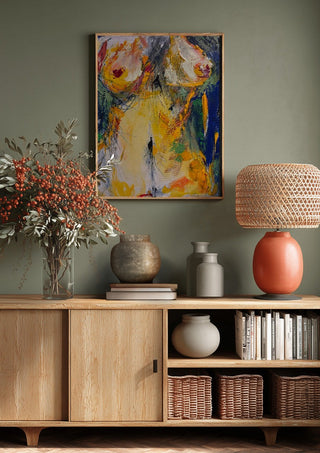 Torso in Yellow by René J above a wooden sideboard on a sage green wall