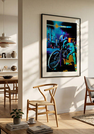 Bike Boys by Pelecan Schneider in a black frame in a bright dining room with wooden chairs
