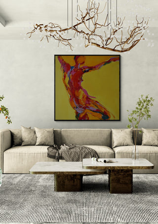 Reaching Figure by René J in a black frame above a beige sofa under a branch chandelier