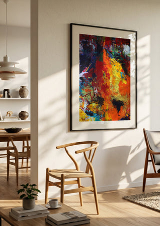 Red Abstract by René J in a black frame in a bright dining room with wooden chairs
