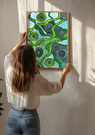 Green Cells by JHN.ByHjort being hung on a sunlit wall