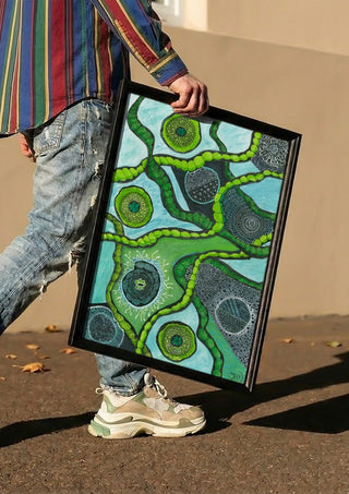 Green Cells by JHN.ByHjort carried in a black frame along a sunny street